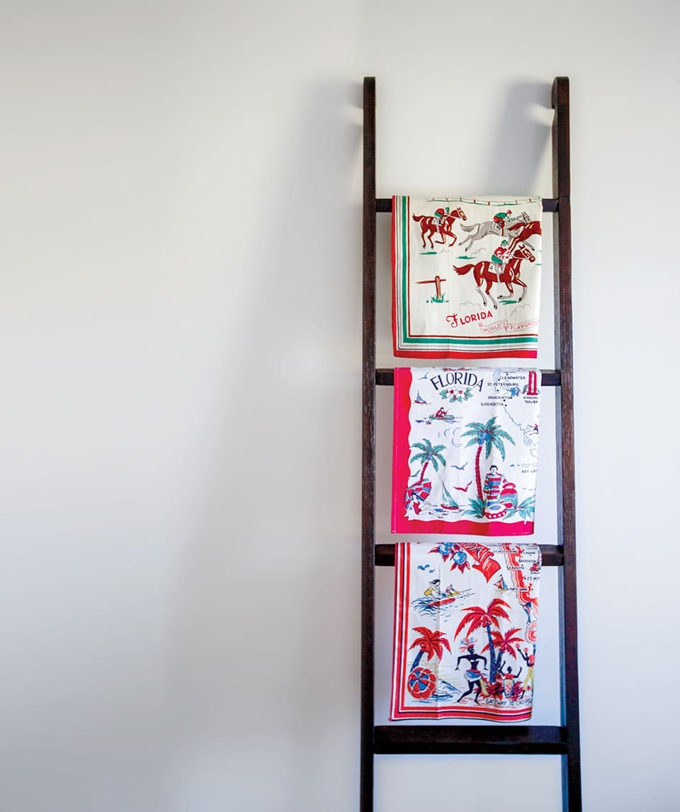 Floridiana: The Great Tablescape 1 (Tea towels, top to bottom) Horse racing motif, $40; Palm trees, bathing beauties and sailboat print, $35; Calypso dancing and waterskiing pattern, $40