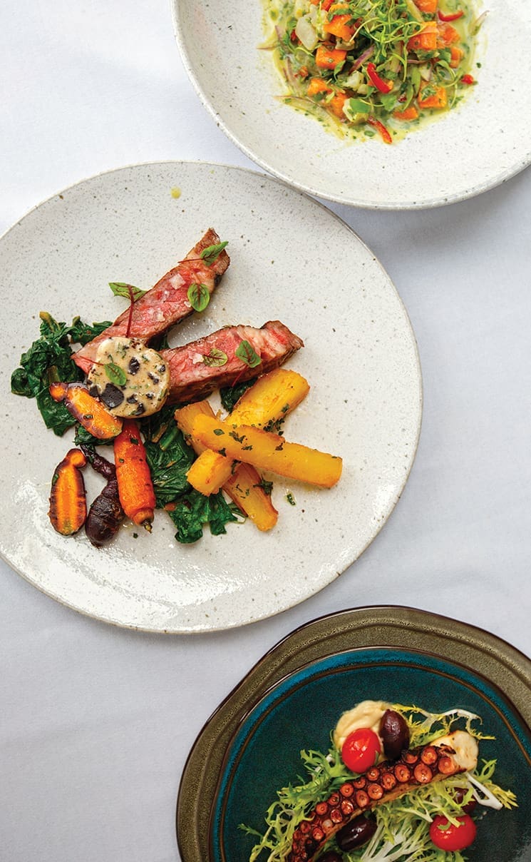 Green coconut ceviche, grilled ribeye with garlic yucca and black garlic truffle butter, and grilled octopus with chickpea purée and salad; Photograph by Jessie Prezza