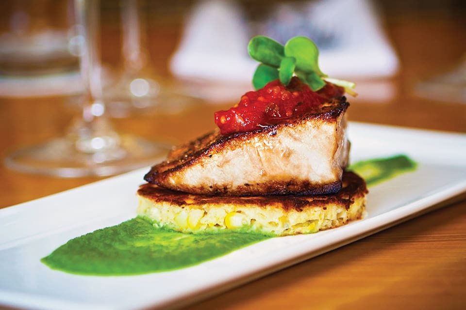 Indigenous Recipes from Chef Steve Phelps 1 Pan-seared Gulf amberjack with griddlecake, basil jalapeño purée and tomato jam, see our blog for recipe; Photograph Kim Longstreet
