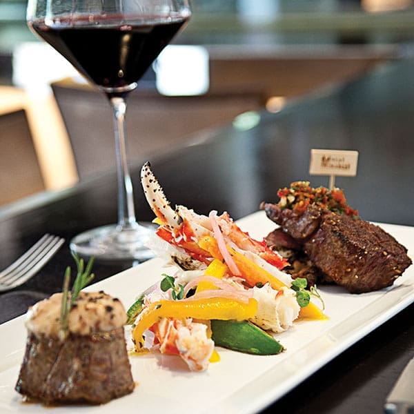 Meat Market Mixed Grill featuring Steamed Crab Legs Prime deckel and Petit Filet Photo Credit Michael Pisarri.600