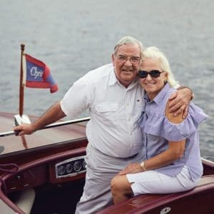 Her Majesty 2 Guy has his arm around Laurie while they smile in their Chris-Craft.
