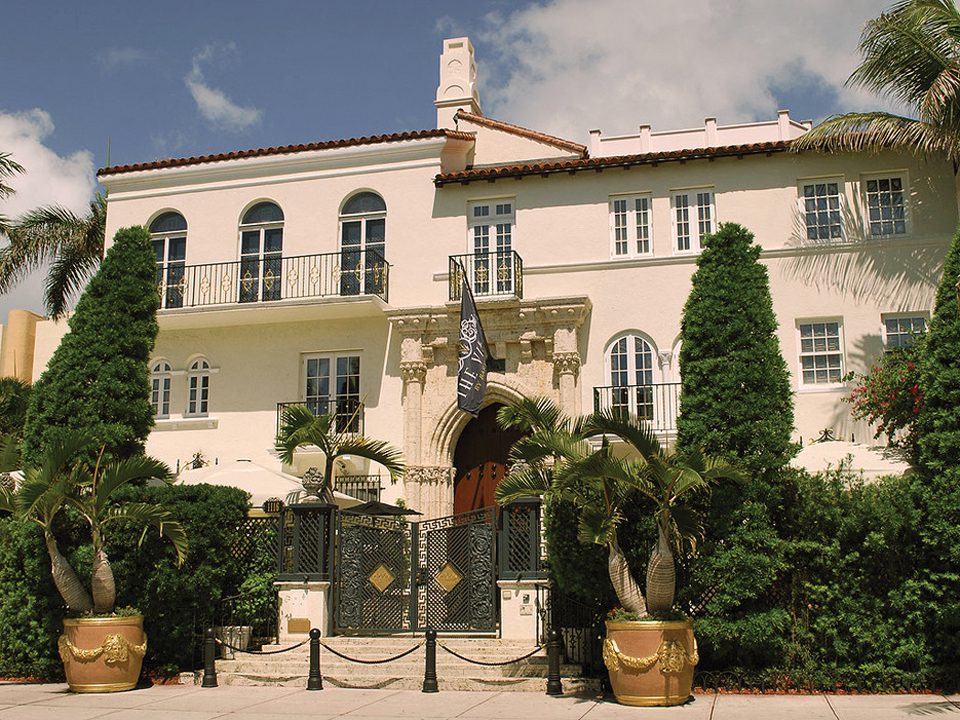 The outdoor view of the hotel, once Gianni Versace’s home. A gate and foliage guard the entrance.