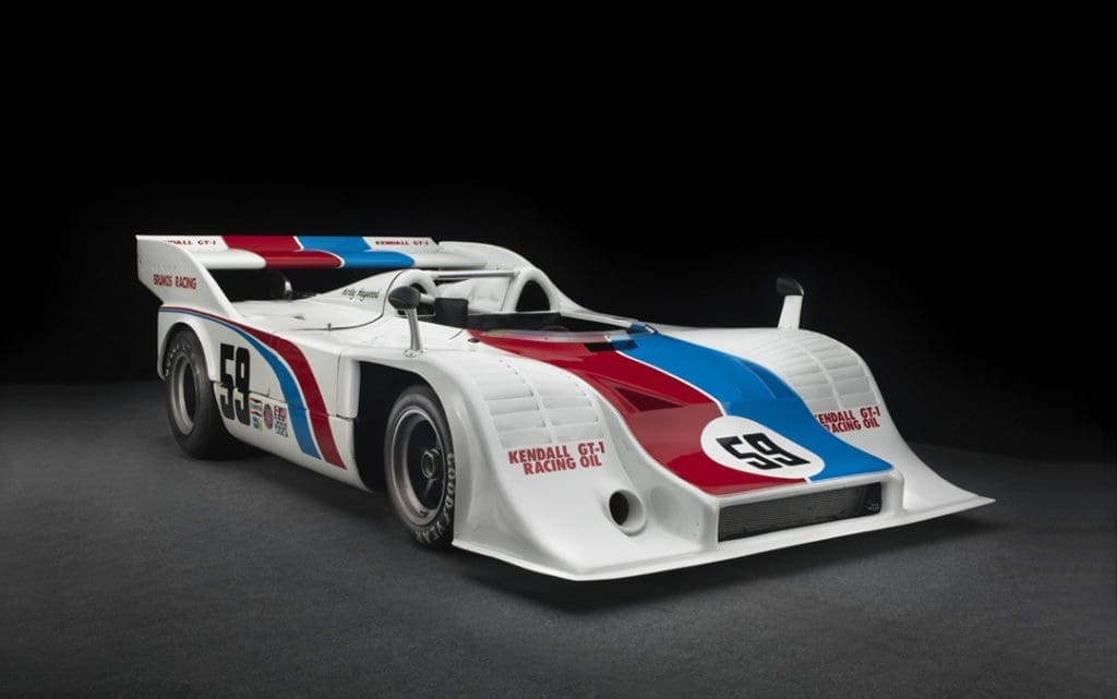 Racing Icon Hurley Haywood Gets Real About His Personal Life & Career 3 The white car has a 59 on the side and front and a blue and red strip stretching from the back to the front.