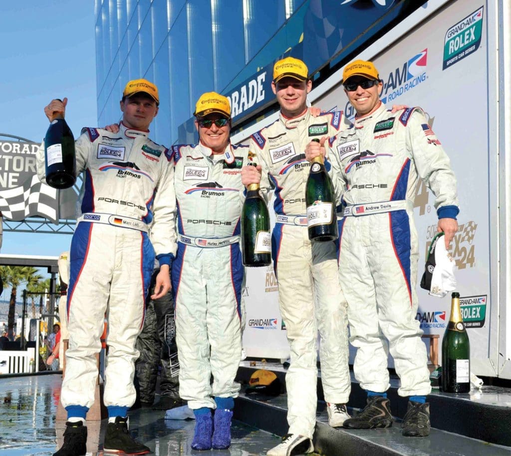 Racing Icon Hurley Haywood Gets Real About His Personal Life & Career 14 Haywood and his teammates smile with their celebratory bottles.