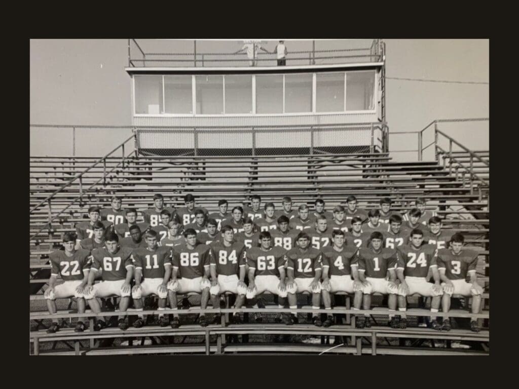 The Black Football Players Who Changed the Game Forever 2 Leonard George is visible in the second row of this Jesuit High School team photo taken on the bleachers. He is the only Black player in the black and white photo.