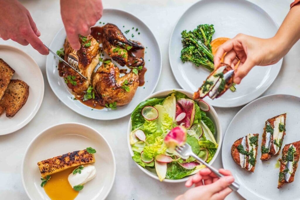 Why New York City Chefs are Fleeing to Florida 1 Six Foirette dishes with various hands sampling them.