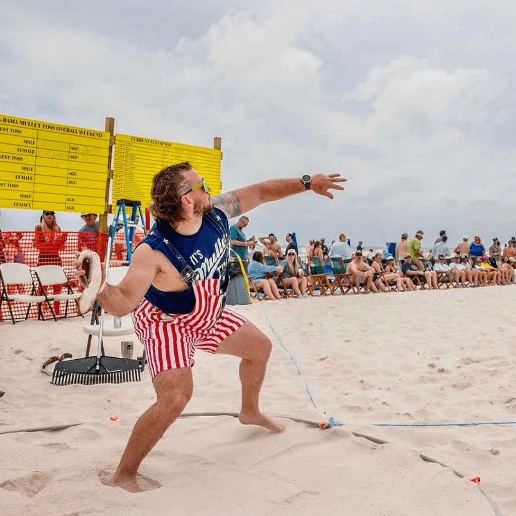 Flora-Bama Mullet Toss: A Tradition Across State Lines 1 Man throws Mullet fish at the annual Flora-Bama Mullet Toss.