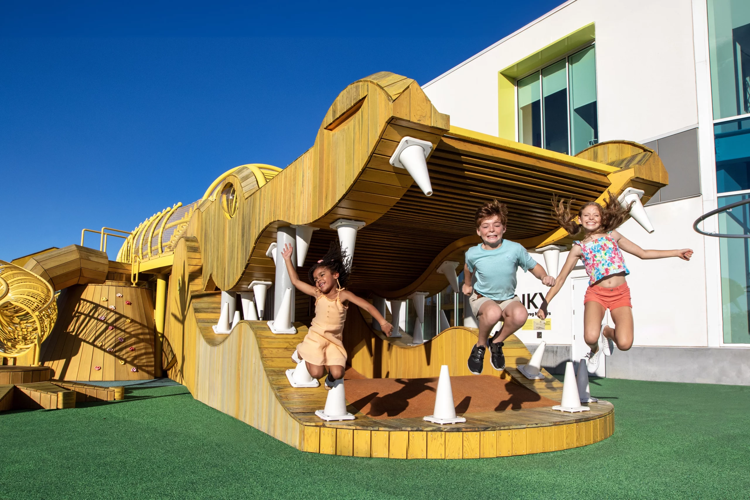 Five Unexpected Central Florida Adventures 3 Three kids jump off a giant alligator-shaped jungle gym.