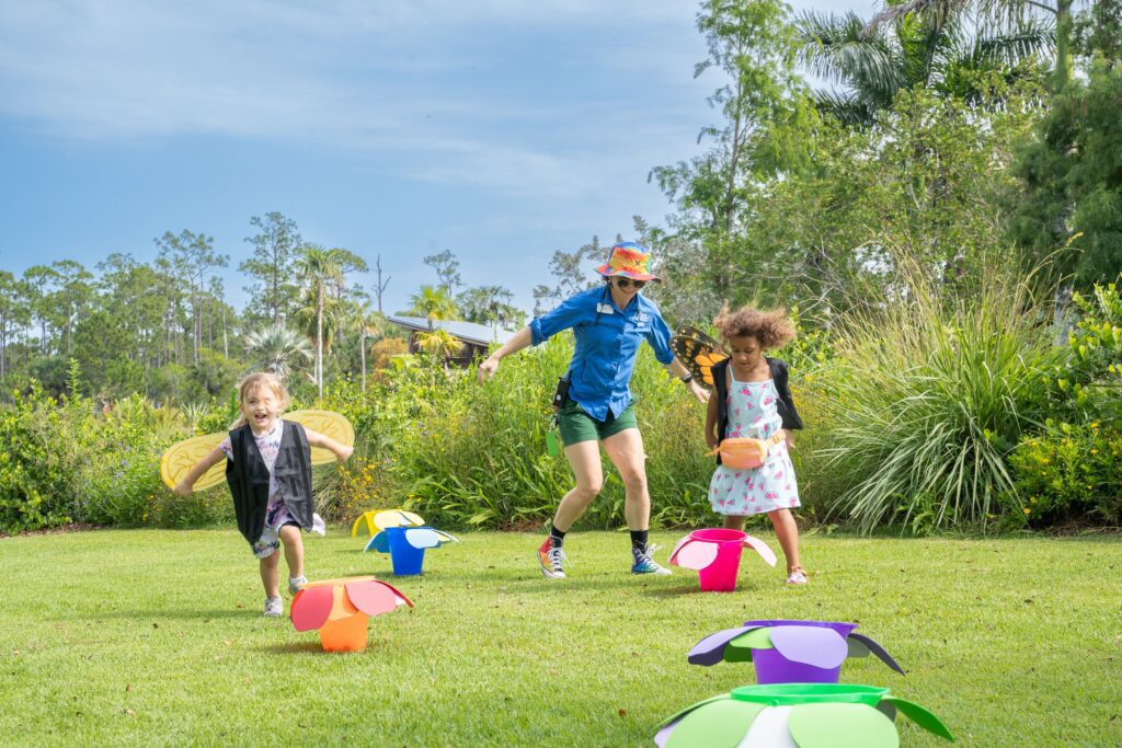 Joyful children run around at the sunny Naples Botanical Garden. 