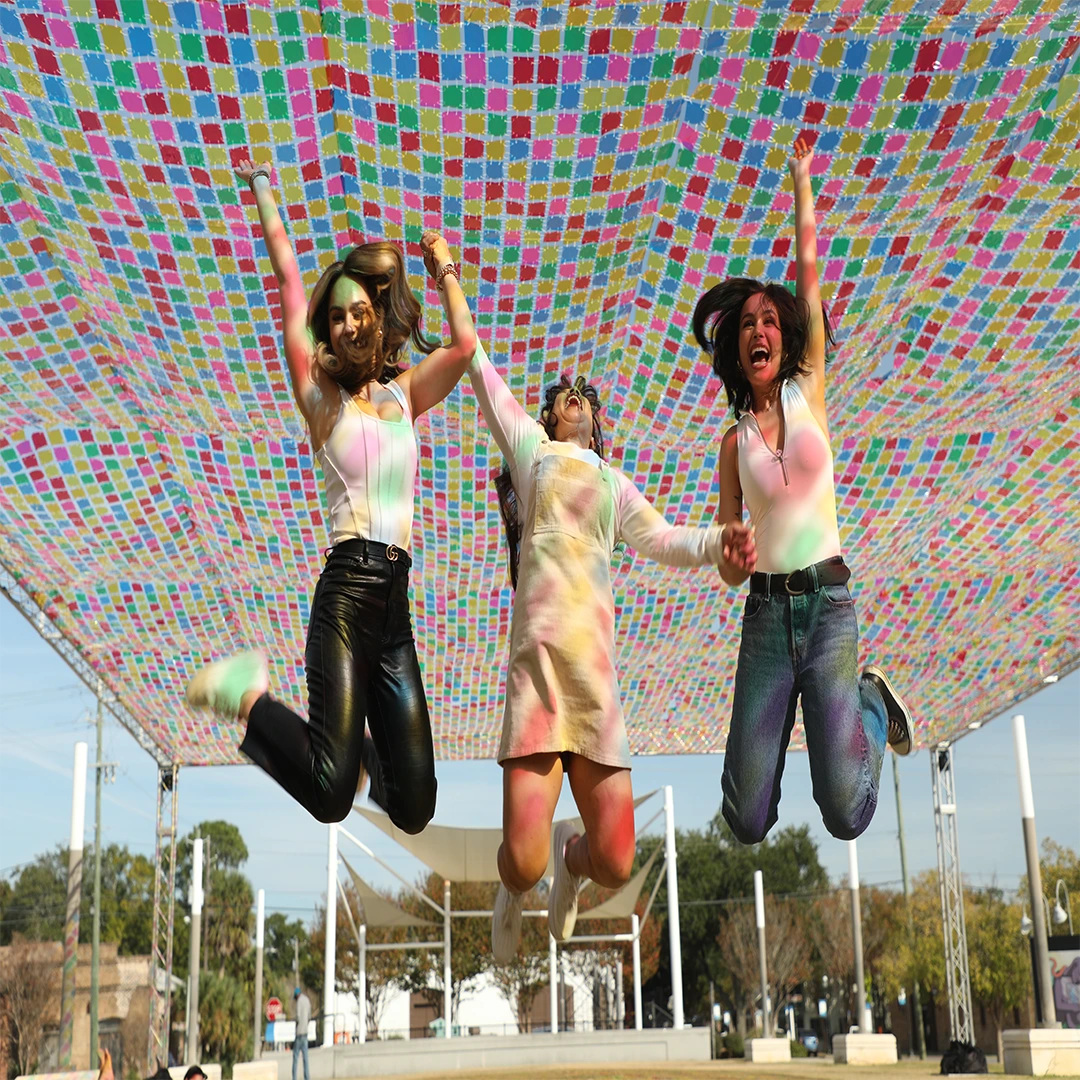 Women underneath the Magic Carpet attraction at Foo Festival.