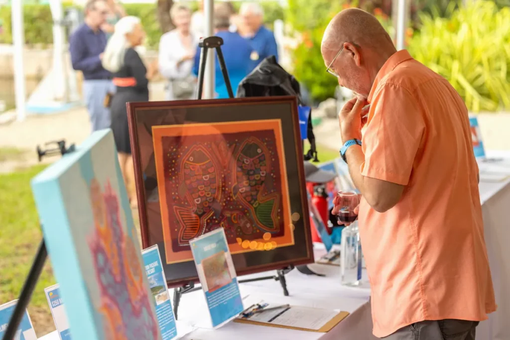 What To Do This October in Florida 7 A man looking at marine life art.