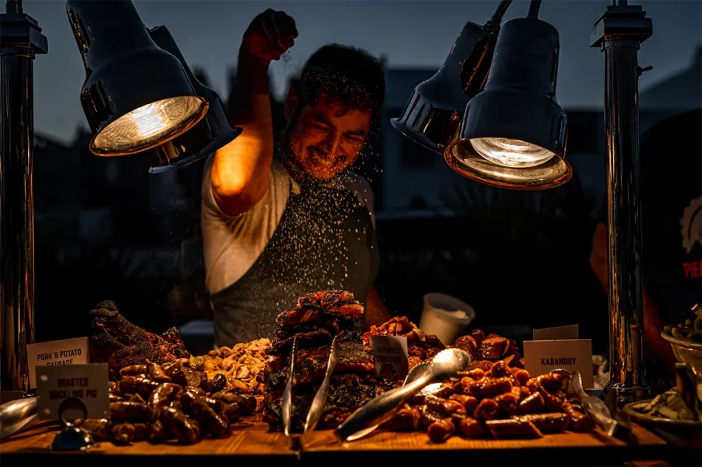 A man prepares a savory charcuterie display.