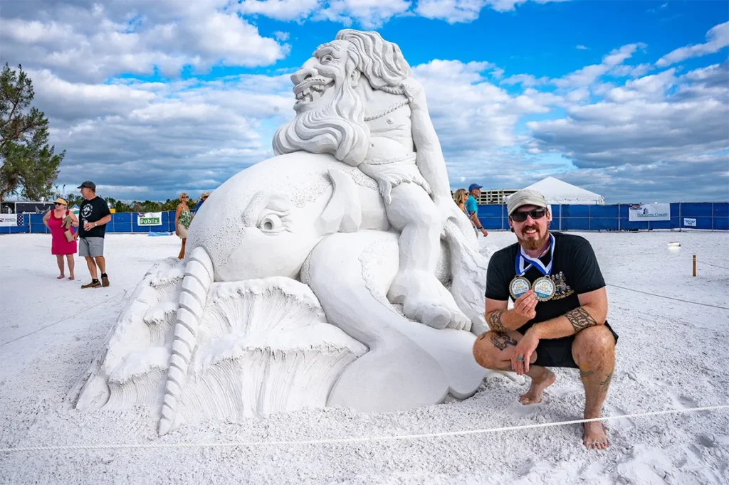 Dean Arscott beside his sand sculpture.