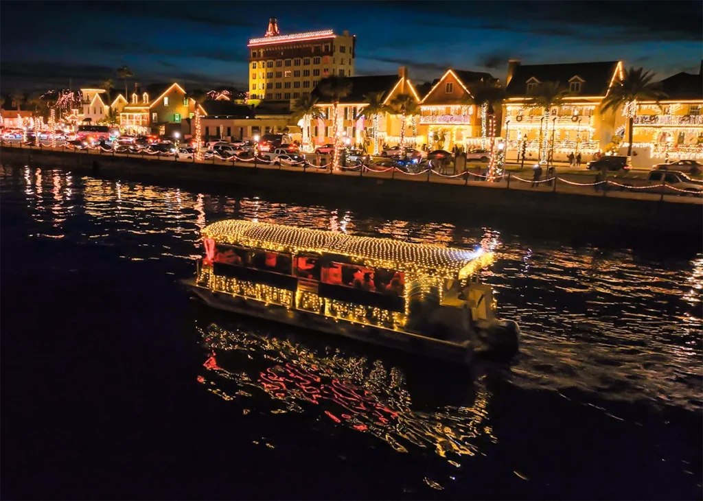 A boat decorated with holiday lights.