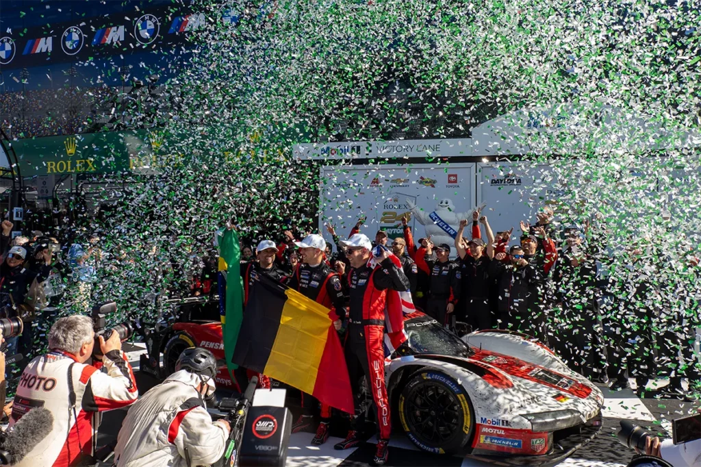 Race car drivers celebrating their victory.