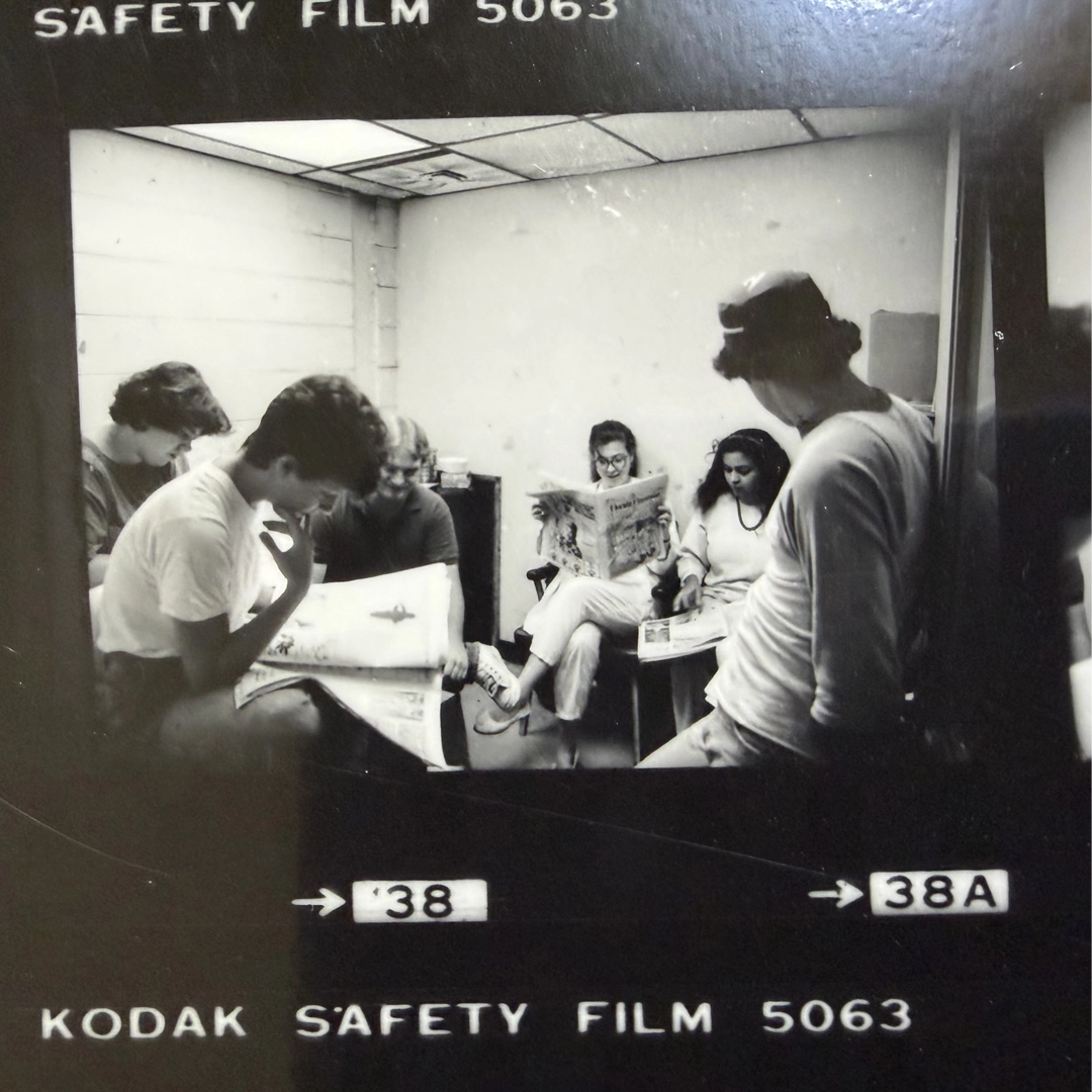 Diane Roberts, center, and the Flambeau staff read a November 1985 issue; front page news from August 1985. Photography courtesy of Diane Roberts, Florida State University Digital Repository.
