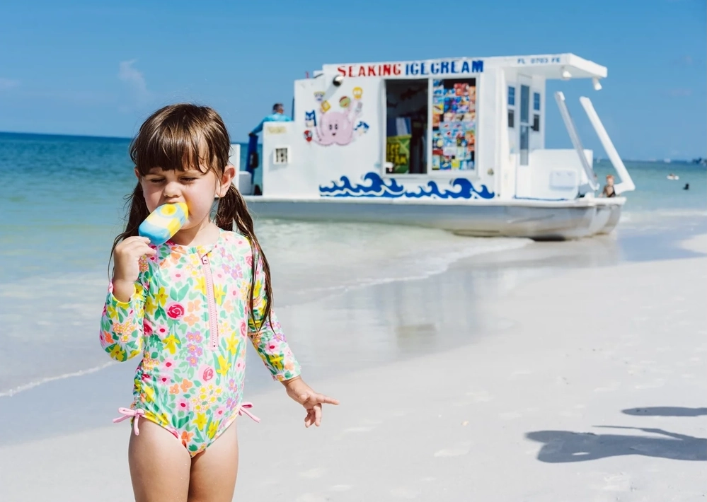 A Wild Florida Childhood Captured on Camera 4 a girl in front of an ice cream boat on the beach