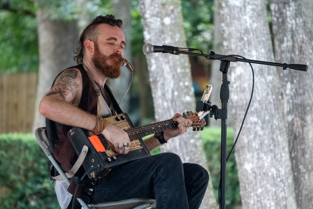 What to do this July in Florida 2 Man sings and plays guitar at Swamp Stomp.